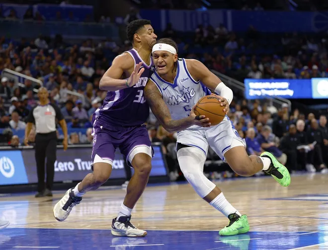 Mar 26, 2026; Orlando, Florida, USA; Orlando Magic forward Paolo Banchero (5) drives to the basket as Sacramento Kings center Dylan Cardwell (32) attempts to defend in the second half at Kia Center.