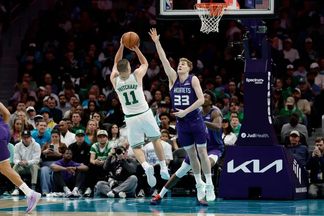 Mar 29, 2026; Charlotte, North Carolina, USA; Boston Celtics guard Payton Pritchard (11) shoots over Charlotte Hornets forward Liam McNeeley (33) during the second half at Spectrum Center. Mandatory Credit: Brian Westerholt-Imagn Images