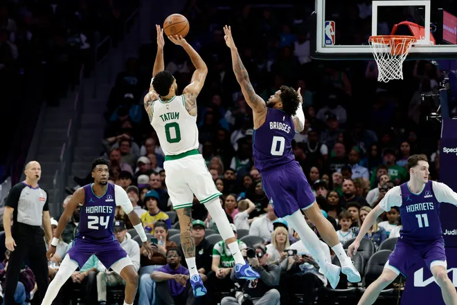Mar 29, 2026; Charlotte, North Carolina, USA; Boston Celtics forward/guard Jayson Tatum (0) shoots over Charlotte Hornets forward Miles Bridges (0) during the second half at Spectrum Center. Mandatory Credit: Brian Westerholt-Imagn Images