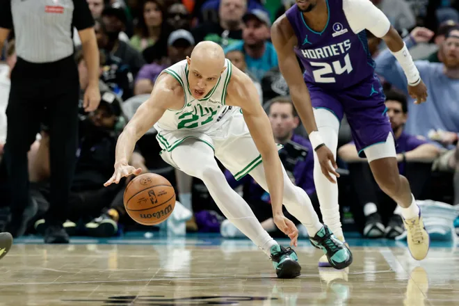 Mar 29, 2026; Charlotte, North Carolina, USA; Boston Celtics guard Jordan Walsh (27) dives after a loose ball during the second quarter against the Charlotte Hornets at Spectrum Center. Mandatory Credit: Brian Westerholt-Imagn Images