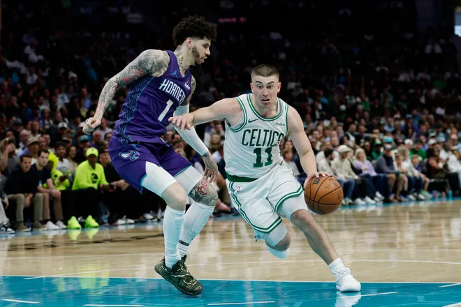 Mar 29, 2026; Charlotte, North Carolina, USA; Boston Celtics guard Payton Pritchard (11) drives past Charlotte Hornets guard LaMelo Ball (1) during the second quarter at Spectrum Center. Mandatory Credit: Brian Westerholt-Imagn Images