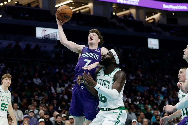 Mar 29, 2026; Charlotte, North Carolina, USA; Charlotte Hornets guard/forward Kon Knueppel (7) drives to the basket past Boston Celtics center Neemias Queta (88) during the second half at Spectrum Center. Mandatory Credit: Brian Westerholt-Imagn Images