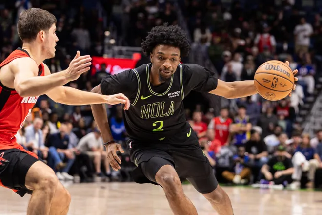 Mar 29, 2026; New Orleans, Louisiana, USA; New Orleans Pelicans forward Herbert Jones (2) dribbles against Houston Rockets guard Reed Sheppard (15) during the first half at Smoothie King Center. Mandatory Credit: Stephen Lew-Imagn Images