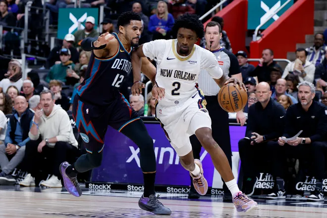 Mar 26, 2026; Detroit, Michigan, USA; New Orleans Pelicans forward Herbert Jones (2) dribbles defended by Detroit Pistons forward Tobias Harris (12) in the first half at Little Caesars Arena. Mandatory Credit: Rick Osentoski-Imagn Images