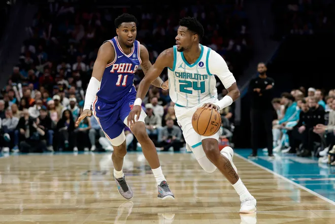 Mar 28, 2026; Charlotte, North Carolina, USA; Charlotte Hornets forward Brandon Miller (24) drives past Philadelphia 76ers forward Justin Edwards (11) during the third quarter at Spectrum Center. Mandatory Credit: Brian Westerholt-Imagn Images