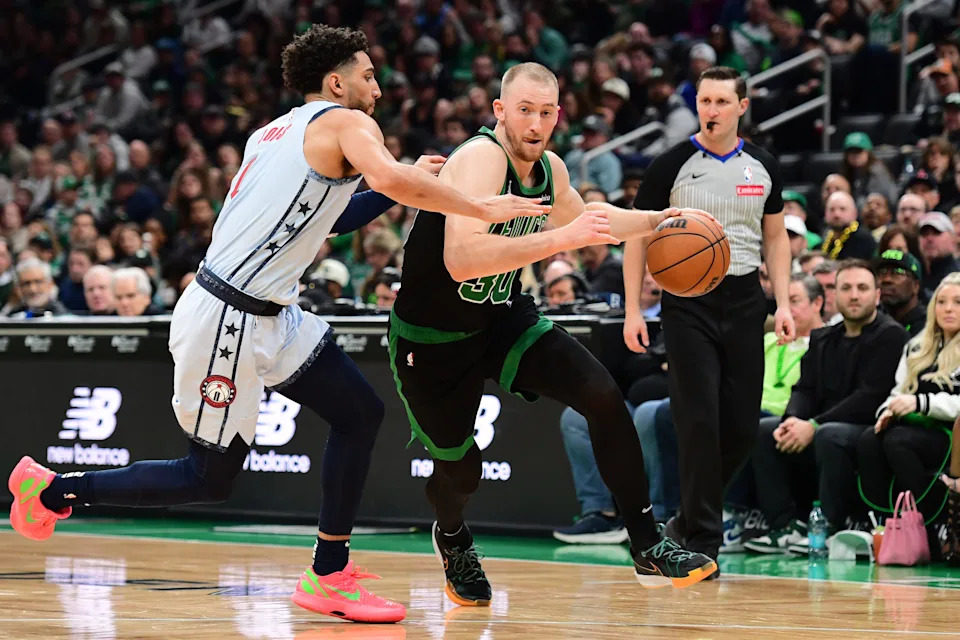 Apr 6, 2025; Boston, Massachusetts, USA; Boston Celtics forward Sam Hauser (30) controls the ball while Washington Wizards guard Colby Jones (1) defends during the second half at TD Garden. Mandatory Credit: Bob DeChiara-Imagn Images