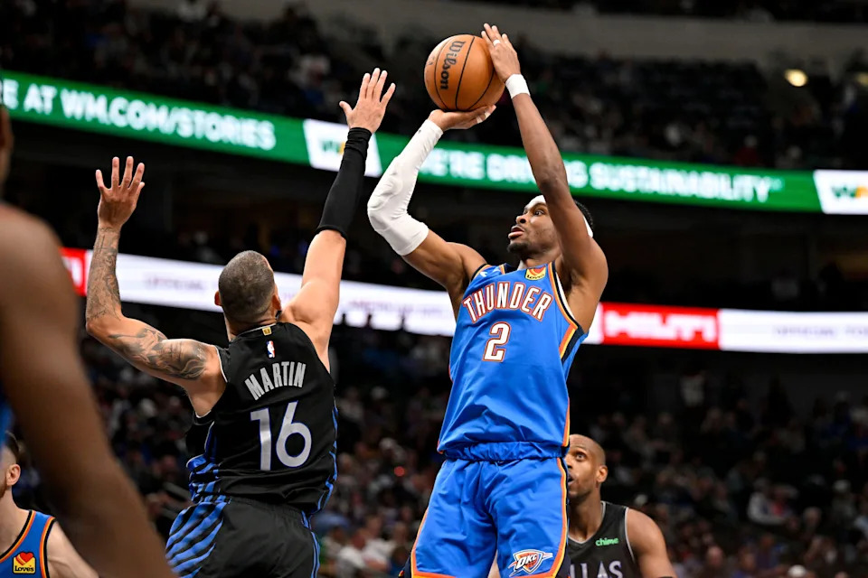 Mar 1, 2026; Dallas, Texas, USA; Oklahoma City Thunder guard Shai Gilgeous-Alexander (2) makes a jump shot over Dallas Mavericks forward Caleb Martin (16) during the second half at the American Airlines Center. Mandatory Credit: Jerome Miron-Imagn Images