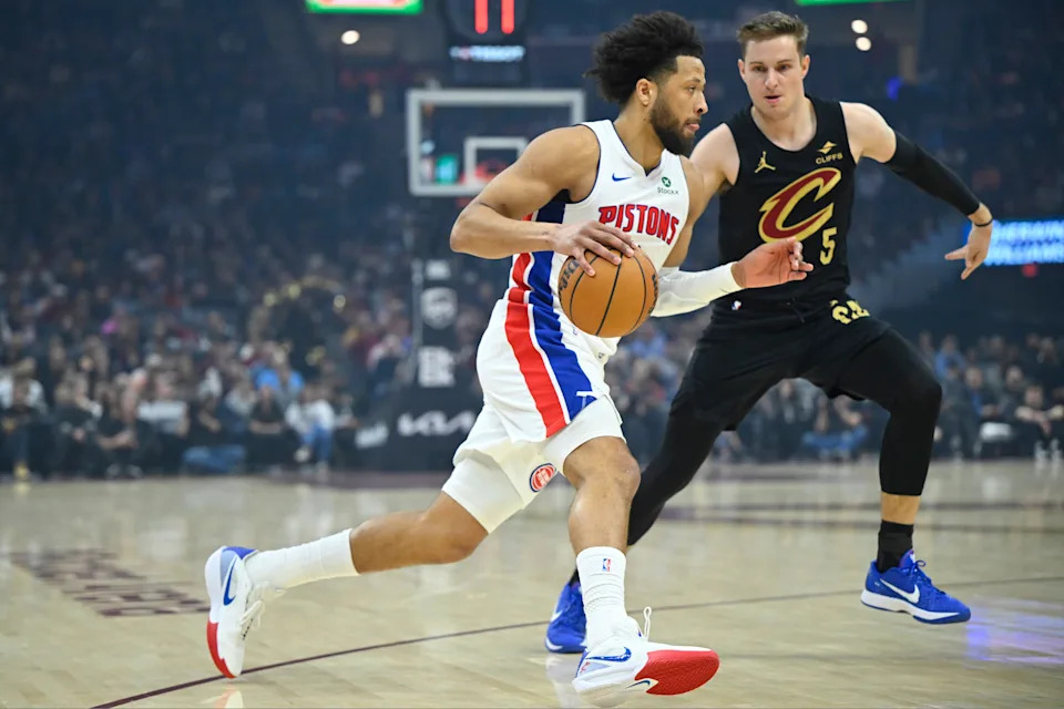 Mar 3, 2026; Cleveland, Ohio, USA; Detroit Pistons guard Cade Cunningham (2) dribbles beside Cleveland Cavaliers guard Sam Merrill (5) in the first quarter at Rocket Arena. Mandatory Credit: David Richard-Imagn Images