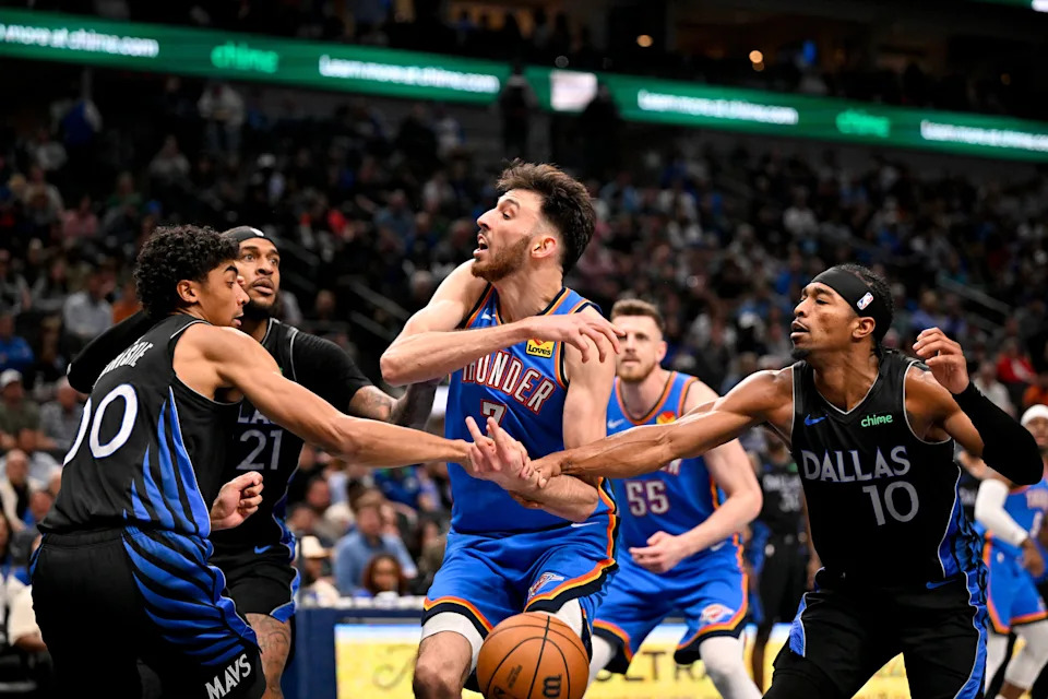 Mar 1, 2026; Dallas, Texas, USA; Dallas Mavericks guard Max Christie (00) and guard Brandon Williams (10) knock the ball away from Oklahoma City Thunder center Chet Holmgren (7) during the second half at the American Airlines Center. Mandatory Credit: Jerome Miron-Imagn Images