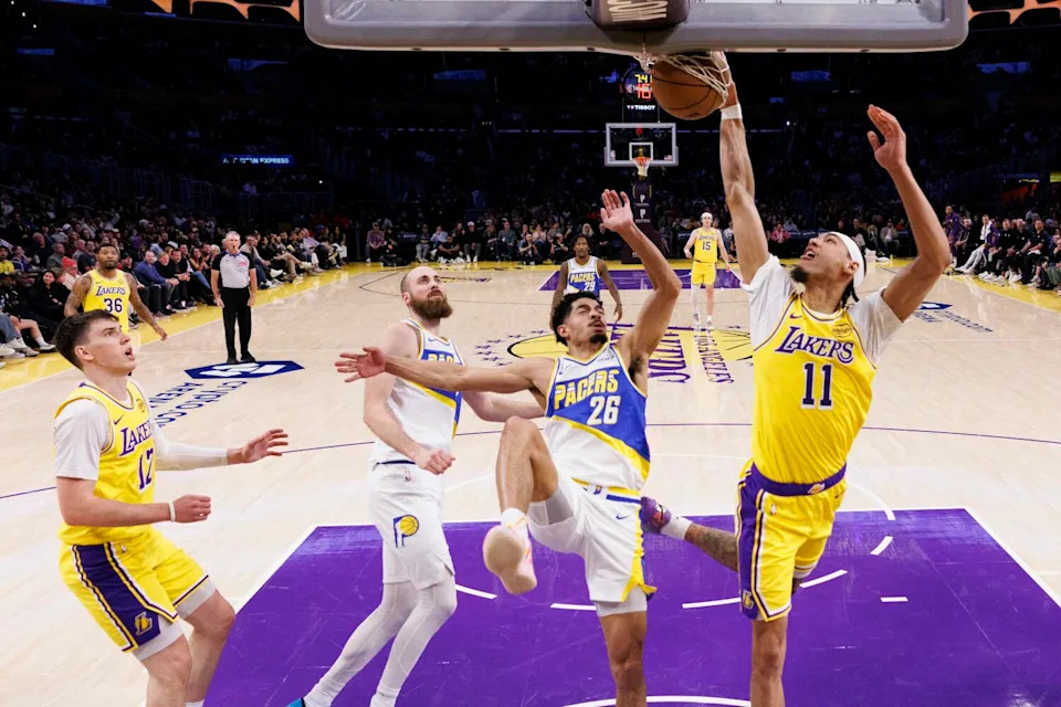Lakers center Jaxson Hayes scores at the rim in front of Indiana Pacers guard Ben Sheppard on Friday at Crypto.com Arena.