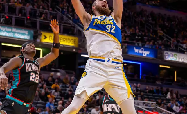 Indiana Pacers center Jay Huff (32) dunks during the second half of an NBA basketball game against the Memphis Grizzlies in Indianapolis, Sunday, March 1, 2026. (AP Photo/Doug McSchooler)