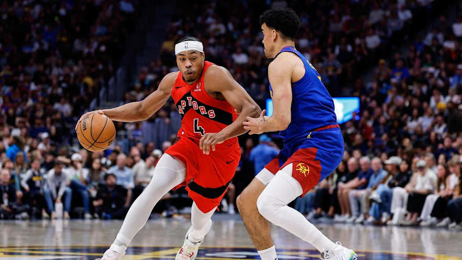 Toronto Raptors forward Scottie Barnes controls the ball as Denver Nuggets forward Spencer Jones defends