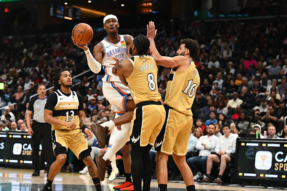 Mar 21, 2026; Washington, District of Columbia, USA; Oklahoma City Thunder guard Shai Gilgeous-Alexander (2) passes the ball past Washington Wizards guard Jaden Hardy (8) and forward Anthony Gill (16) during the second half at Capital One Arena. Mandatory Credit: Brad Mills-Imagn Images