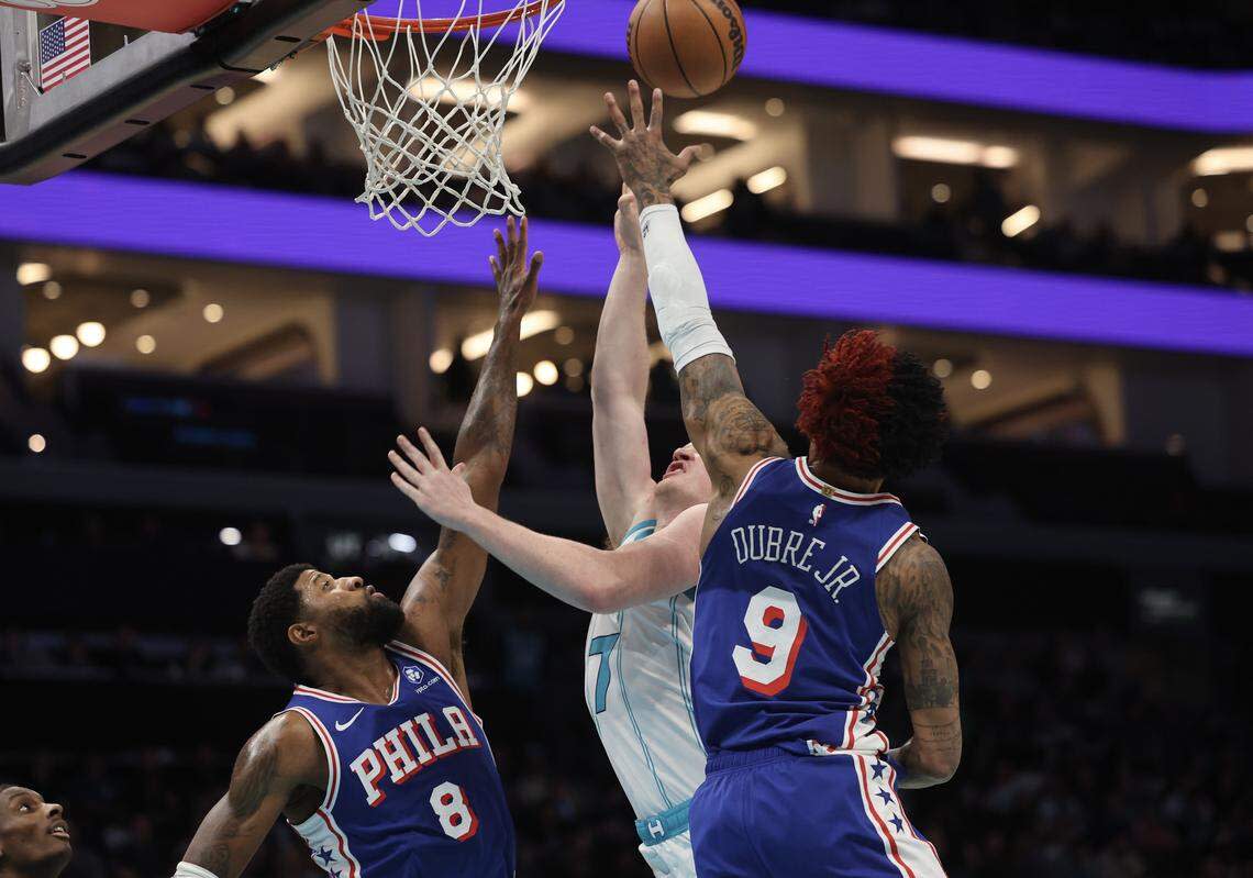 Charlotte Hornets forward Kon Knueppel's shot is blocked by Philadelphia 76ers Paul George (8) and Kelly Oubre Jr. during Saturday’s game at Spectrum Center. 