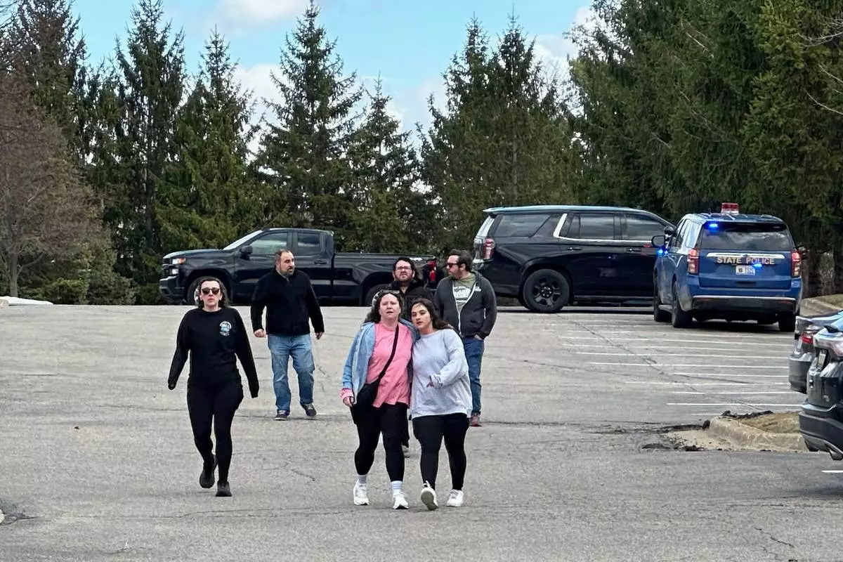 People gather near Temple Israel synagogue in West Bloomfield Township, Mich. (AP Photo/Corey Williams)