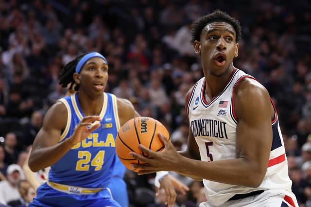 Tarris Reed Jr. (5) of the UConn Huskies posts up against Steven Jamerson II (24) of the UCLA Bruins during the second half in the second round of the 2026 NCAA Men's Basketball Tournament at Xfinity Mobile Arena on Sunday, March 22, 2026, in Philadelphia. 