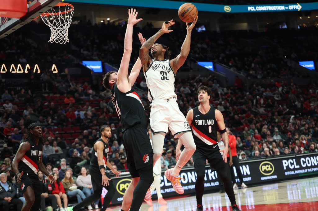 Nets center Nic Claxton (33) shoots the ball over Portland Trail Blazers center Donovan Clingan (23) as Trail Blazers’ forward Deni Avdija (8) watches during the second half at Moda Center. IMAGN IMAGES via Reuters Connect