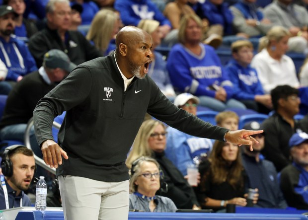 Valparaiso head coach Roger Powell Jr. directs his team during the first half of an NCAA college basketball game against Kentucky in Lexington, Ky., Friday, Nov. 7, 2025. (AP Photo/James Crisp)