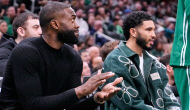 Boston Celtics guard Jaylen Brown, left, applauds while seated alongside forward Jayson Tatum, who both did not play, during the first half of an NBA basketball game against the Sacramento Kings, Friday, Jan. 30, 2026, in Boston. (AP Photo/Charles Krupa)