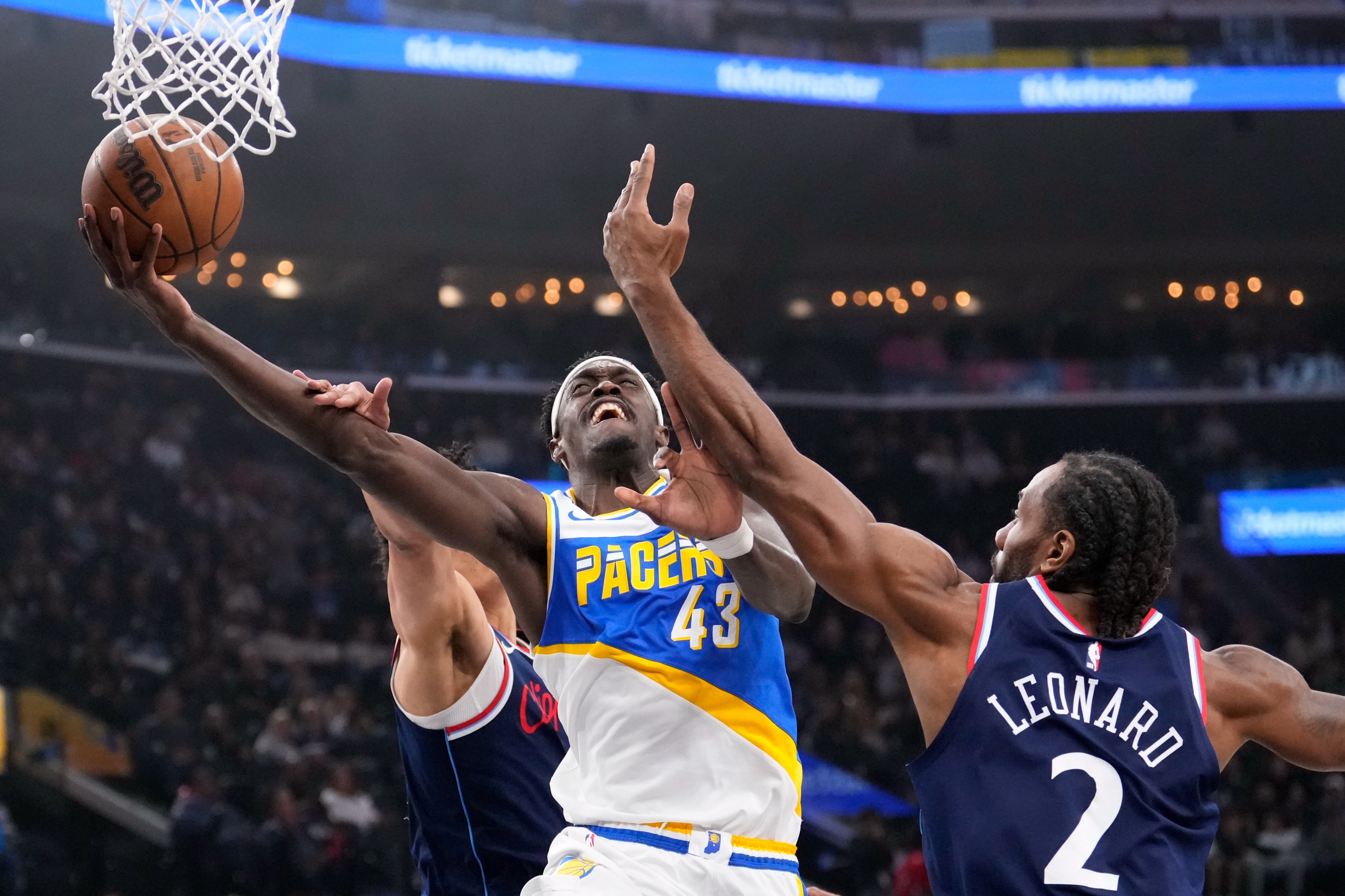 Indiana Pacers forward Pascal Siakam, center, shoots as Clippers guard...