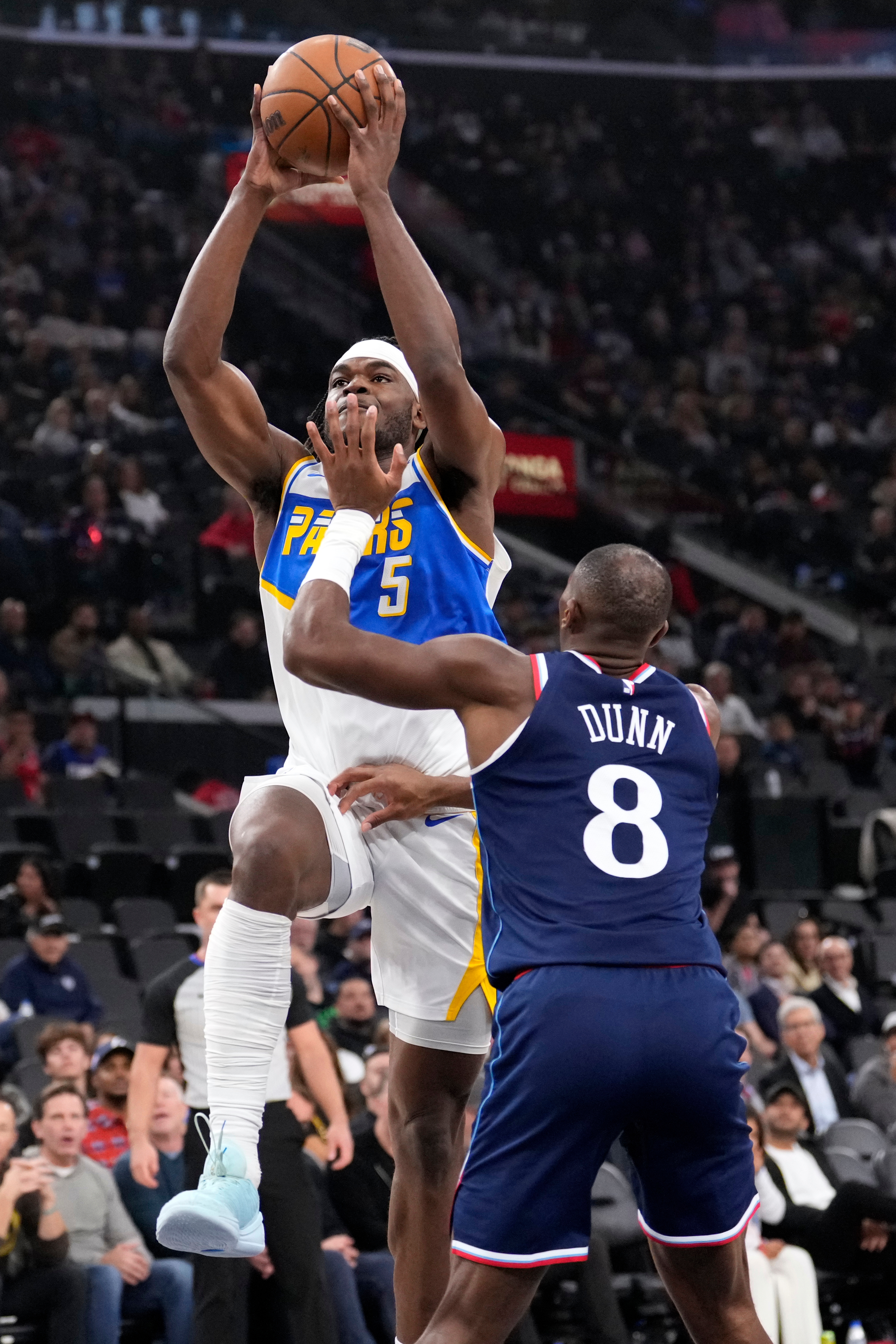 Indiana Pacers forward Jarace Walker, left, shoots as Clippers guard...