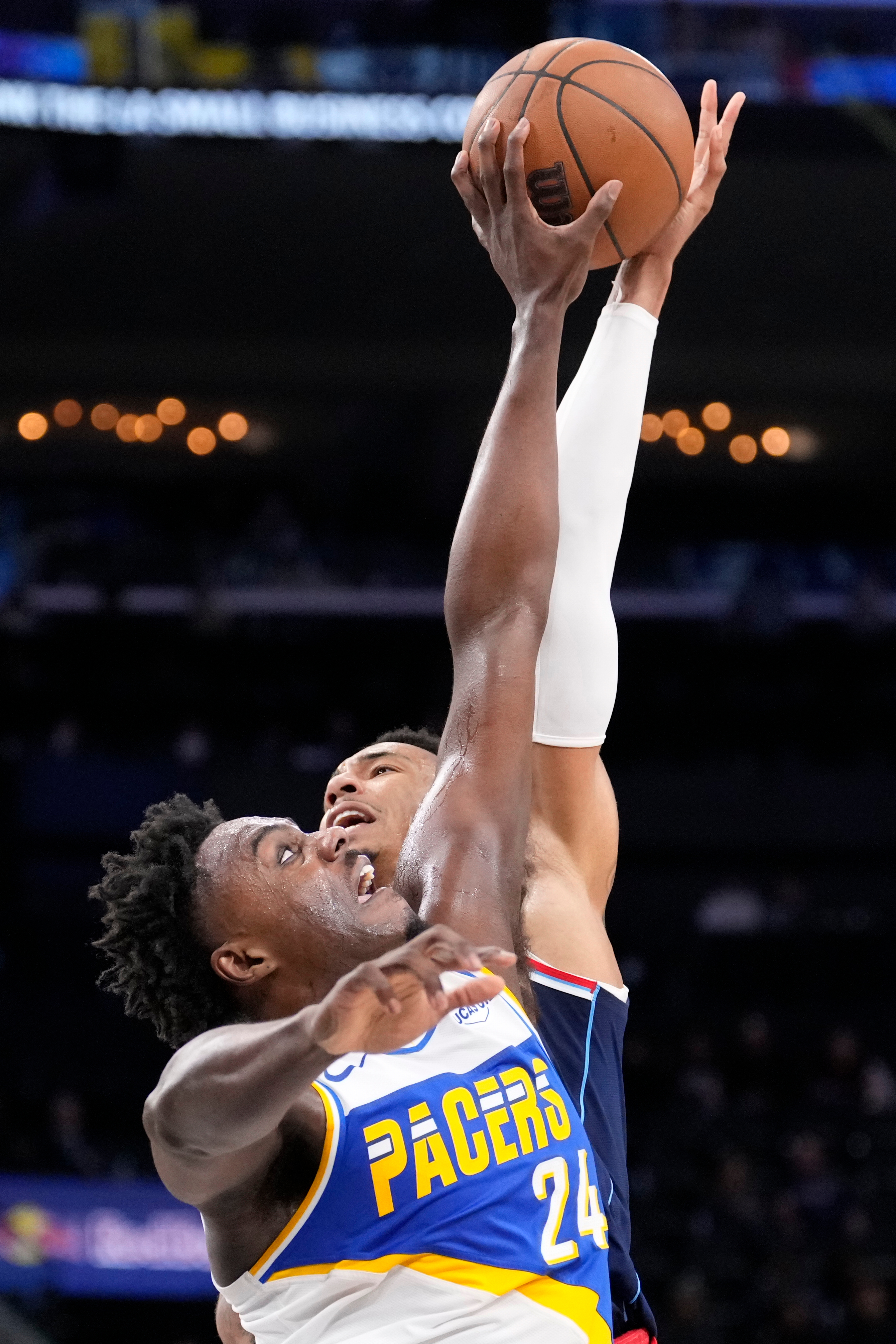 Indiana Pacers guard Kobe Brown, left, blocks the shot of...
