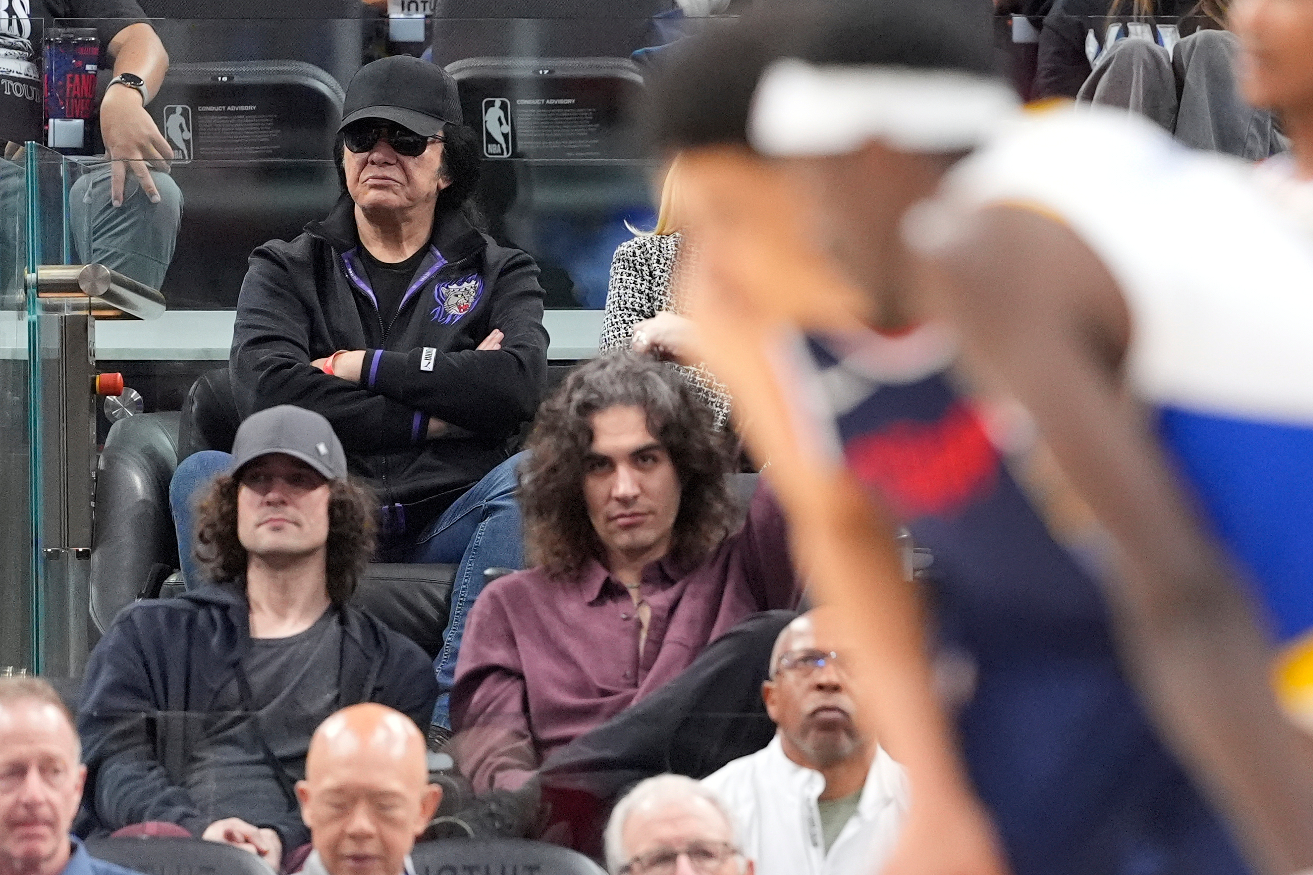 Musician Gene Simmons, upper left, watches during the second half...