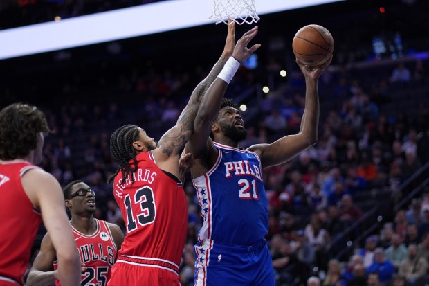 The 76ers' Joel Embiid, right, goes up for a shot against the Bulls' Nick Richards during the first half Wednesday night. (AP Photo/Matt Slocum)