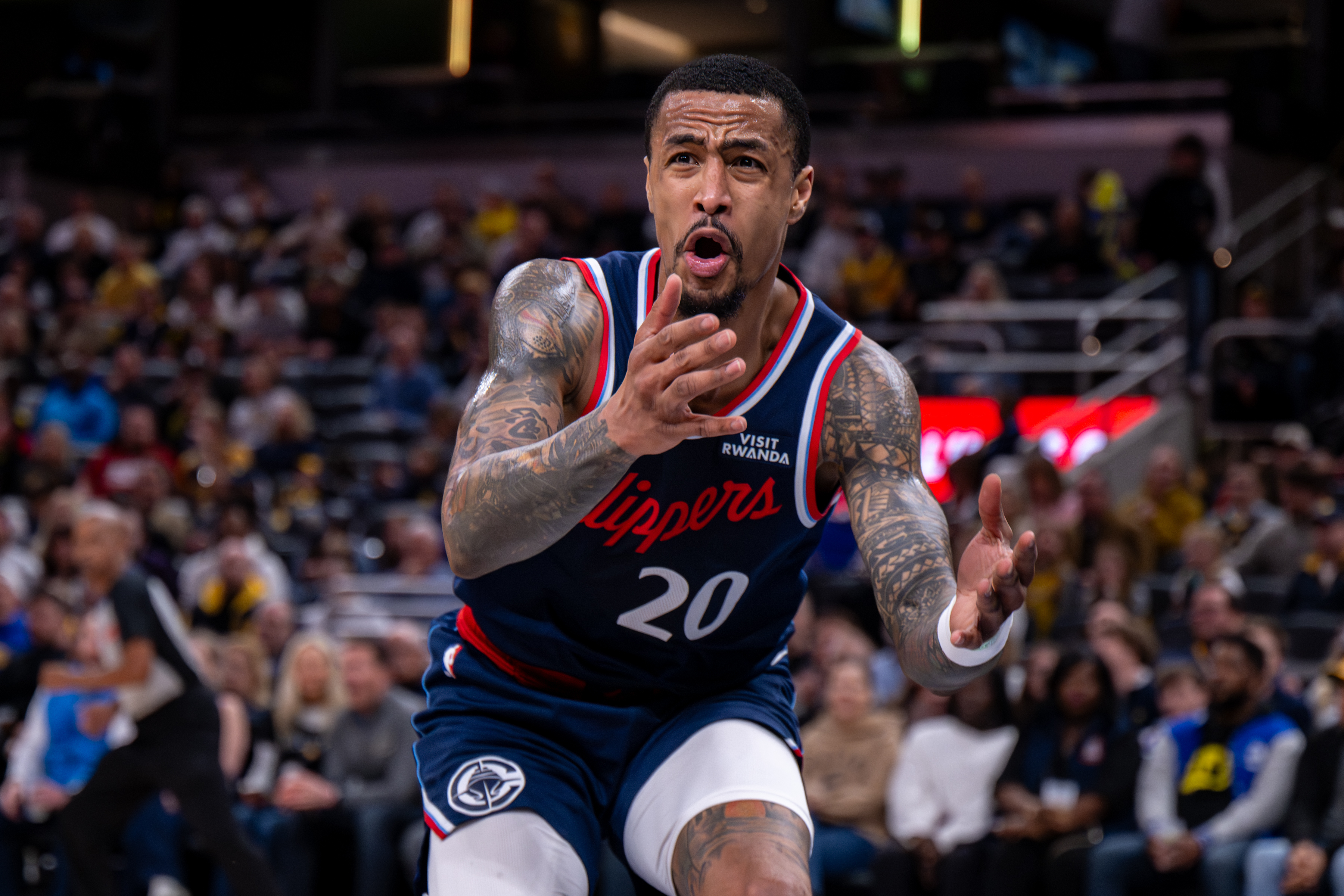 Clippers forward John Collins reacts to a call during the...
