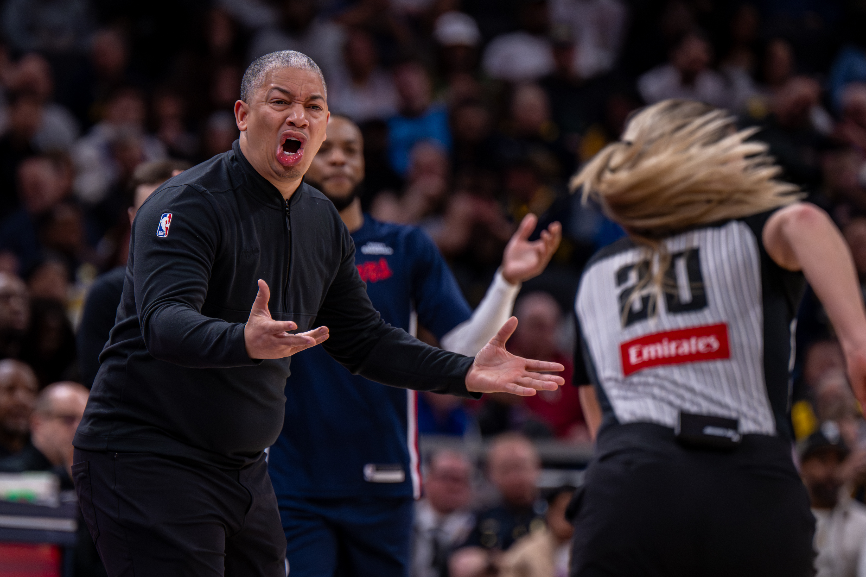 Clippers head coach Tyronn Lue, left, reacts toward an official...