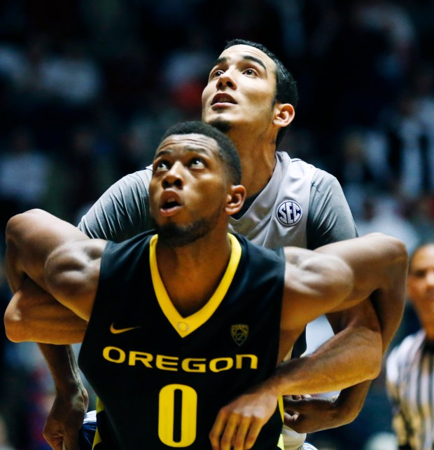 Oregon forward Mike Moser (0) locks up Mississippi forward Anthony Perez (13) as they try for a rebound in the second half of an NCAA college basketball game in Oxford, Miss., on Sunday, Dec. 8, 2013. (AP Photo/Rogelio V. Solis)