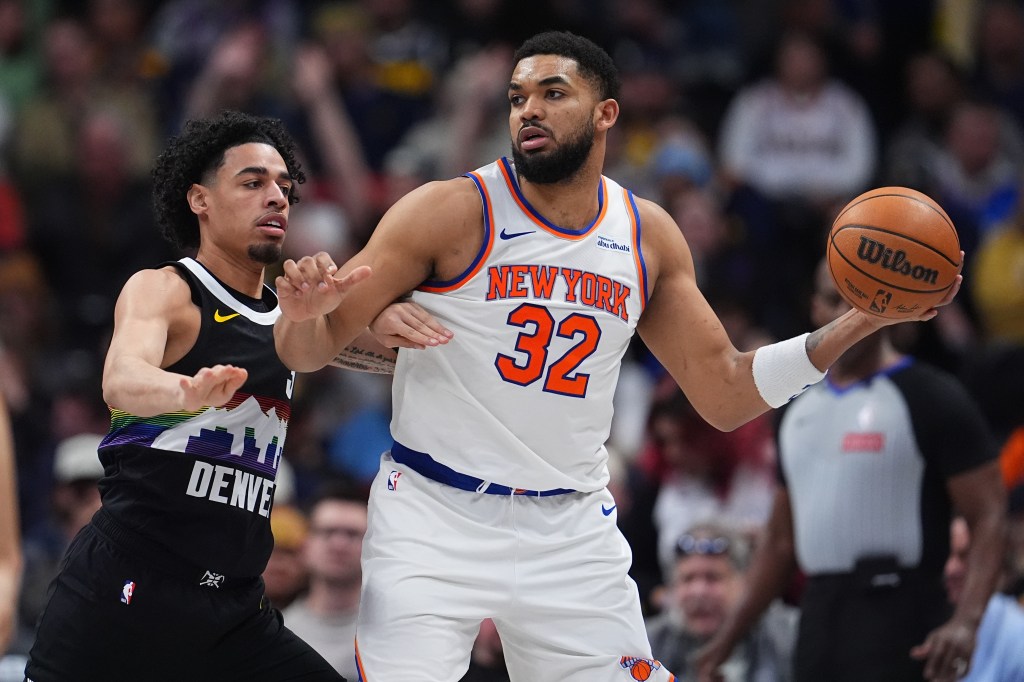 New York Knicks center Karl-Anthony Towns, right, looks to pass the ball as Denver Nuggets guard Julian Strawther, left, defends in the second half of an NBA basketball game Friday, March 6, 2026, in Denver. 