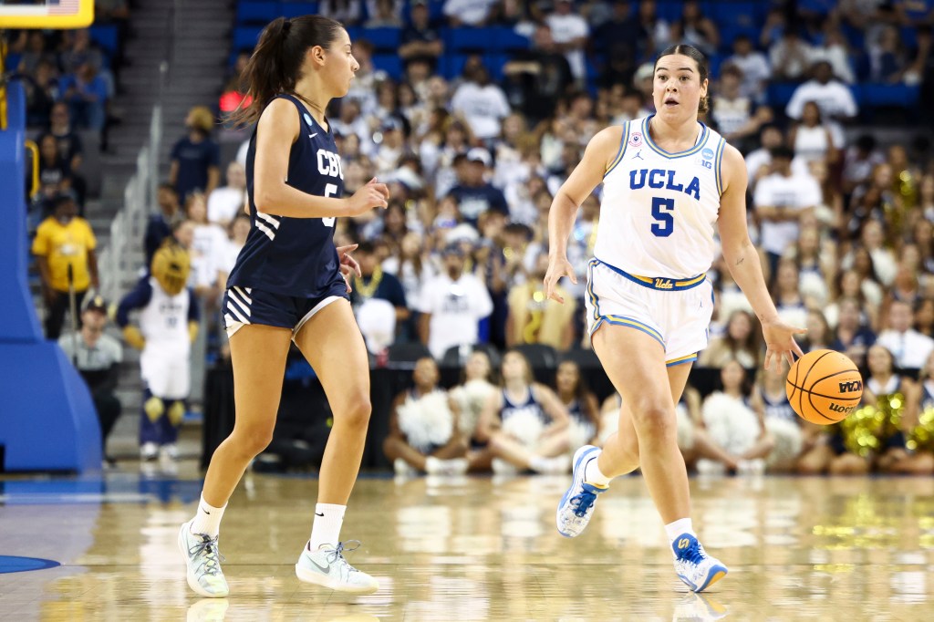 UCLA's Charlisse Leger-Walker dribbles the basketball while being guarded by California Baptist's Filipa Barros.