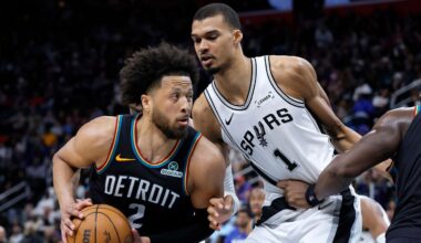 Detroit Pistons guard Cade Cunningham (2) drives against San Antonio Spurs forward Victor Wembanyama (1) during the second half of an NBA basketball game Monday, Feb. 23, 2026, in Detroit. (AP Photo/Duane Burleson)