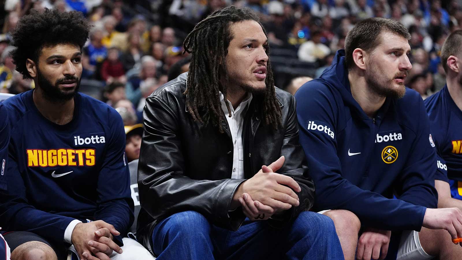 Denver Nuggets guard Jamal Murray (27) and forward Aaron Gordon (32) and center Nikola Jokic (15) on the bench during the second quarter against the Minnesota Timberwolves at Ball Arena.