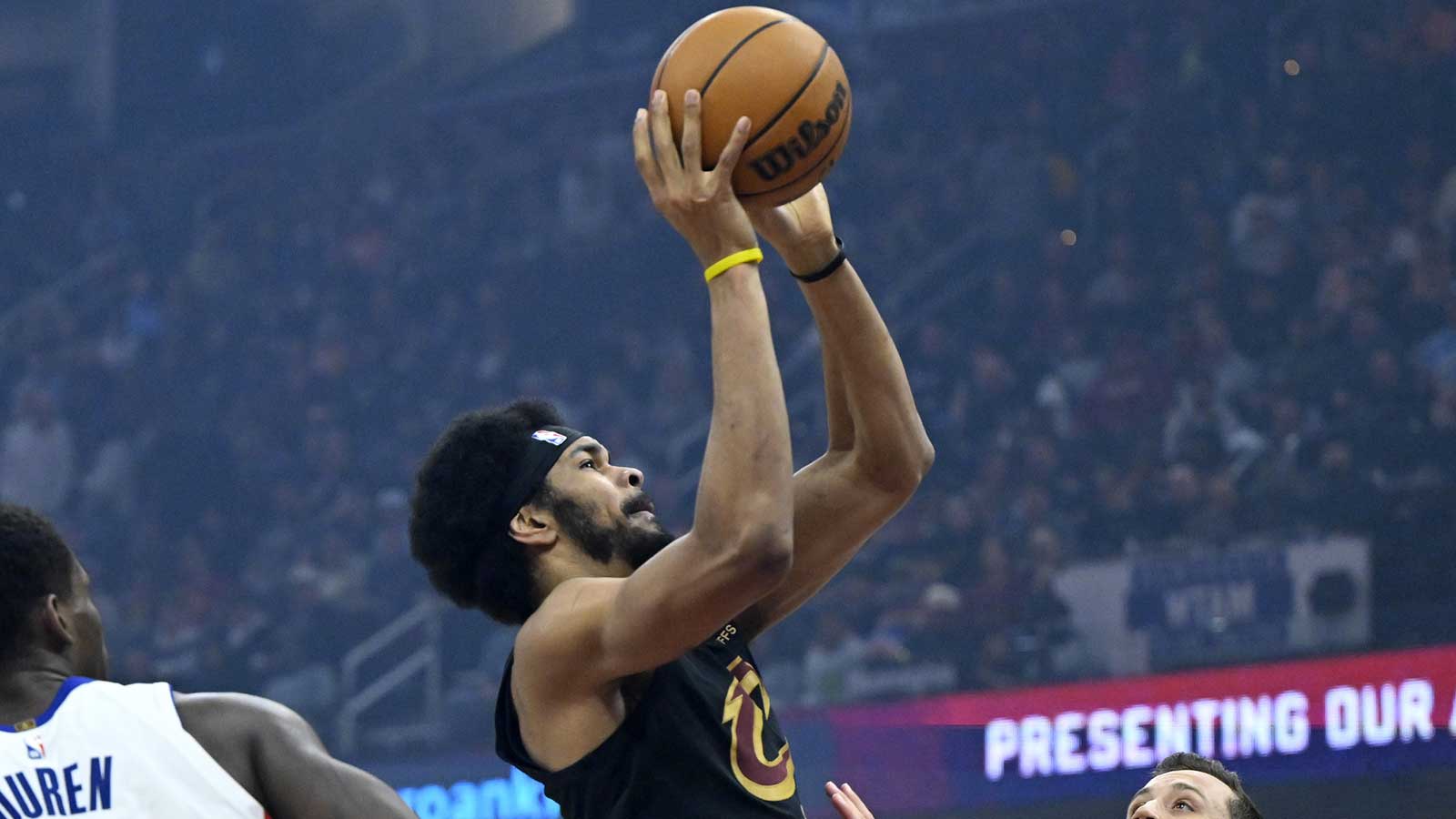 Cleveland Cavaliers center Jarrett Allen (31) drives to the basket beside Detroit Pistons center Jalen Duren (0) and forward Duncan Robinson (55) in the third quarter at Rocket Arena