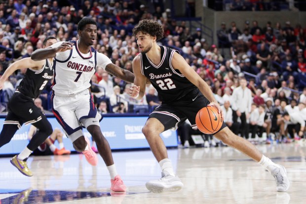 Santa Clara forward Allen Graves (22) drives while pressured by Gonzaga guard Tyon Grant-Foster (7) during the first half of an NCAA college basketball game, Thursday, Jan. 8, 2026, in Spokane, Wash. (AP Photo/Young Kwak)