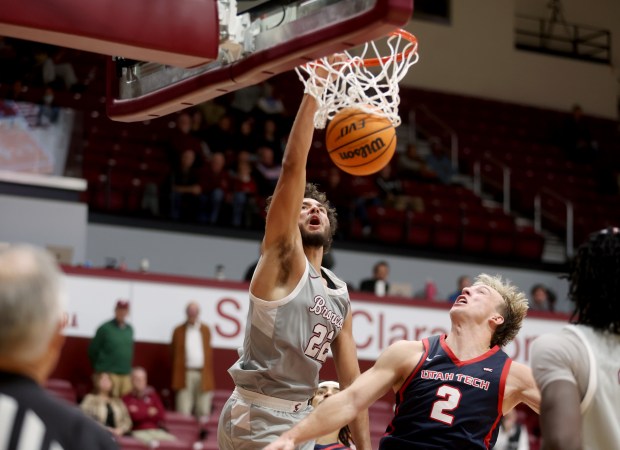Santa Clara University's Allen Graves #22 dunks past Utah Tech's Chance Trujillo #2 in the second half of their NCAA game at Santa Clara University in Santa Clara, Calif., on Wednesday, Dec. 3, 2025. A flagrant foul was called on Trujillo, who was ejected from the game. (Jane Tyska/Bay Area News Group)