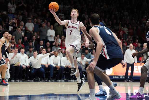 Saint Mary's guard Joshua Dent (7) drives to the basket against Gonzaga guard Davis Fogle (4) during the second half of an NCAA college basketball game in Moraga, Calif., Saturday, Feb. 28, 2026. (AP Photo/Tony Avelar)