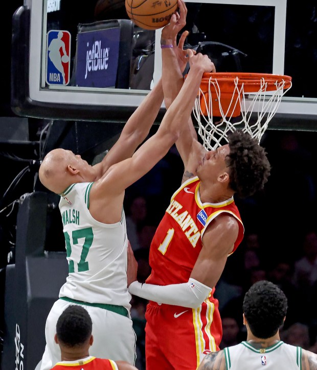 Atlanta Hawks forward Jalen Johnson blocks the dunk attempt of Boston Celtics guard Jordan Walsh on Friday night. (Staff photo by Stuart Cahill/MediaNews Group)