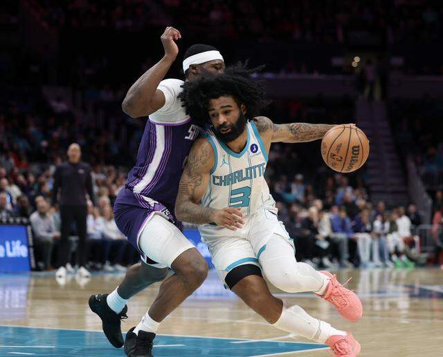 Charlotte Hornets guard Coby White drives past the Sacramento Kings’ Daeqwon Plowden on Tuesday, March 24, 2026 at Spectrum Center in Charlotte.