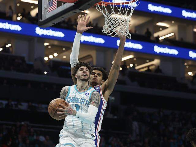 Charlotte Hornets guard LaMelo Ball takes a shot as Philadelphia 76ers forward Dominick Barlow defends at the game on Saturday, March 28, 2026 at Spectrum Center in Charlotte.