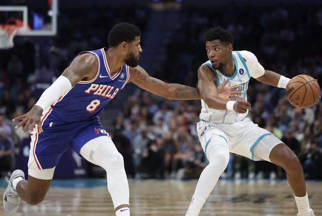 Charlotte Hornets guard Brandon Miller drives past Philadelphia 76ers forward Paul George during the game on Saturday, March 28, 2026 at Spectrum Center in Charlotte.