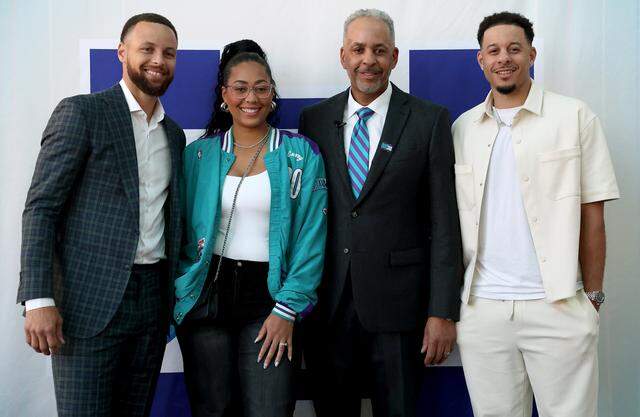 (From left) Steph Curry, Sydel Curry, Dell Curry and Seth Curry pose together during a reception for Dell Curry on Thursday at Spectrum Center. Dell Curry’s No. 30 was retired by the Charlotte Hornets. 