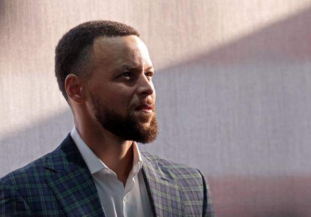 Golden State Warriors star Steph Curry listens to speakers recognize his father, former Charlotte Hornets forward Dell Curry, during a reception Thursday at Spectrum Center.