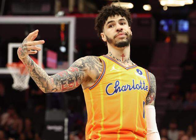 Charlotte Hornets guard LaMelo Ball signals his made three-point basket to a Memphis Grizzlies defender during action at Spectrum Center in Charlotte, NC on Saturday, March 21, 2026.