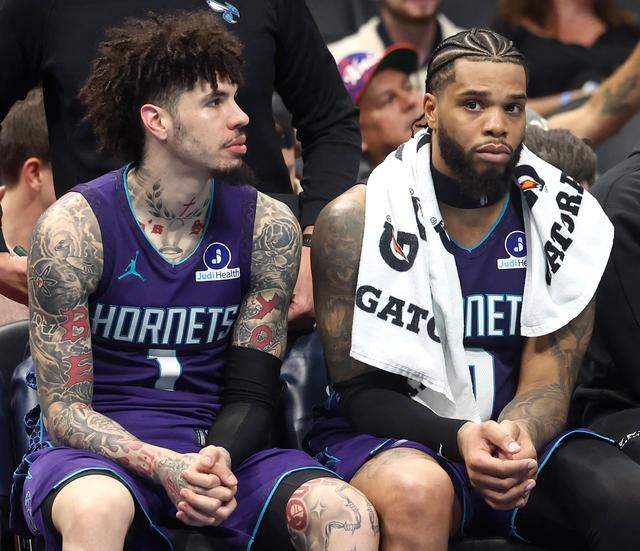 Charlotte Hornets guard LaMelo Ball, left and forward Miles Bridges sit on the bench during action against the New York Knicks at Spectrum Center in Charlotte, North Carolina, on Nov. 26, 2025. The Knicks defeated the Hornets 129-101. 