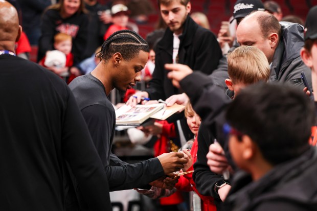 Chicago Bulls forward Isaac Okoro signs autographs before the game against the Milwaukee Bucks at the United Center on Sunday, March 1, 2026. (Eileen T. Meslar/Chicago Tribune)