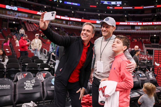 Chicago Bears Coach Ben Johnson, center, takes a selfie with Lou Rassey, left, and his son Will Rassey, 13, before the Chicago Bulls game against the Milwaukee Bucks at the United Center on Sunday, March 1, 2026. (Eileen T. Meslar/Chicago Tribune)