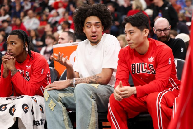 Chicago Bulls forward Noa Essengue speaks to guard Yuki Kawamura as they sit on the bench during the third quarter against the Milwaukee Bucks at the United Center on Sunday, March 1, 2026. (Eileen T. Meslar/Chicago Tribune)